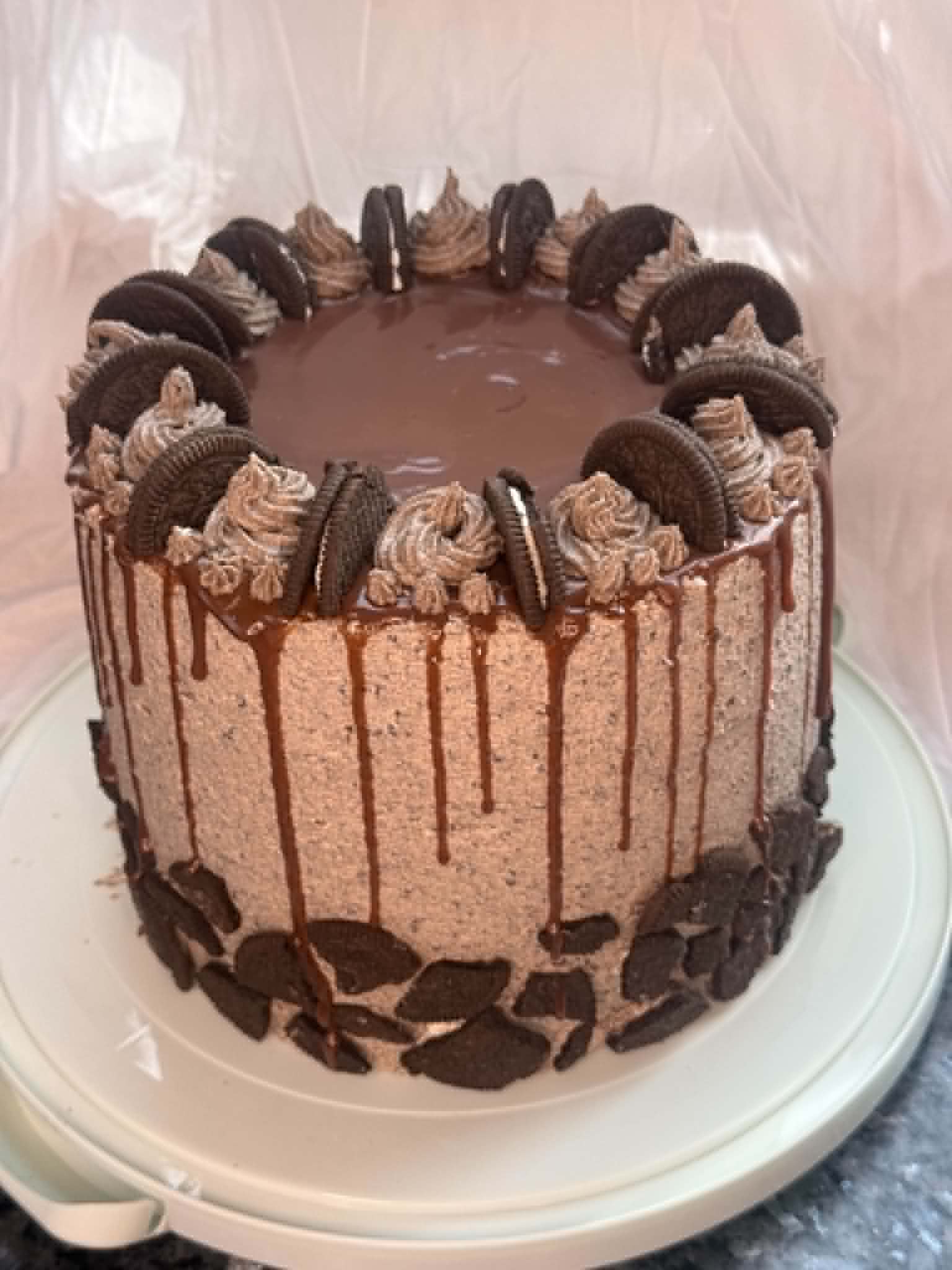 Custom chocolate drip cake with Oreo cookies and piped buttercream